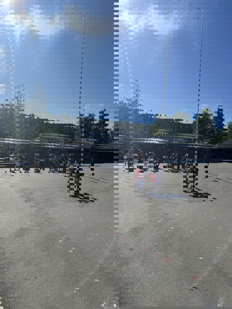 Foto: Trasop skole en gruppe mennesker som står i skolegården